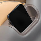 Smartphone resting in a grey high-quality plastic car console storage slot.