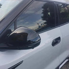 Glossy black side mirror cover for BYD car featuring an integrated NFC sensor.