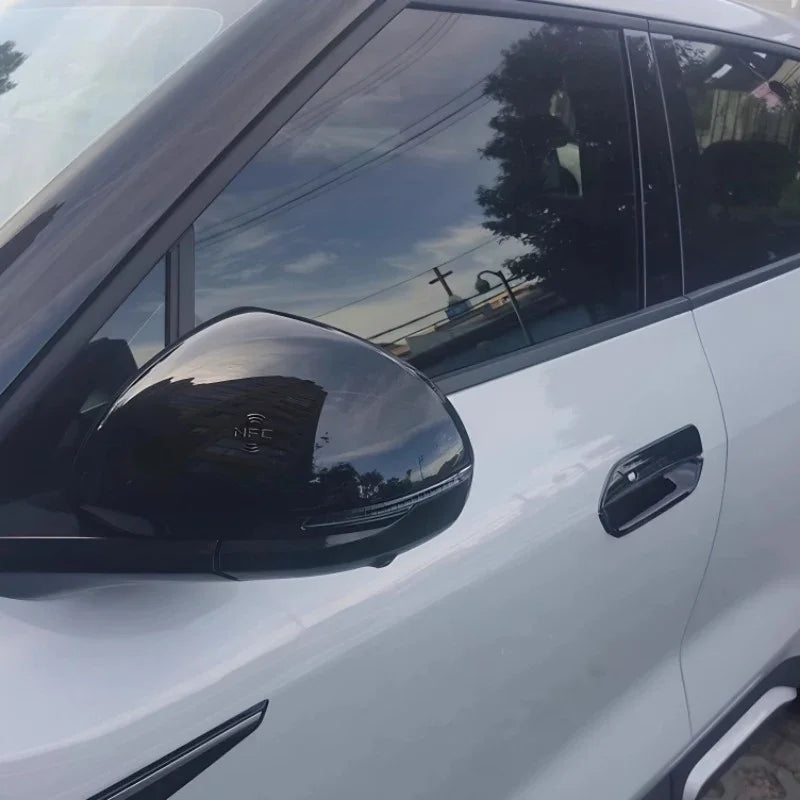 Glossy black side mirror cover for BYD car featuring an integrated NFC sensor.