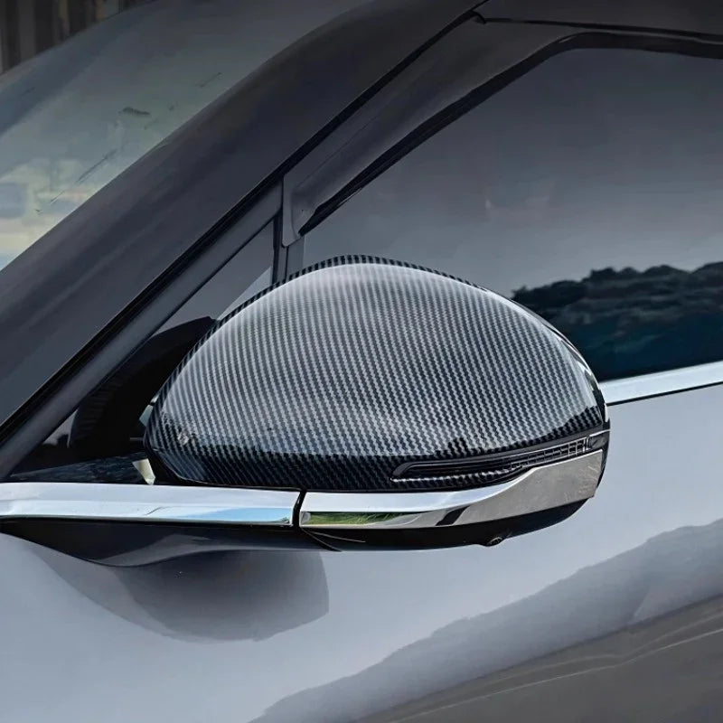 Carbon fiber texture side mirror cover in grey and black for a sleek, sporty car upgrade.