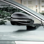 Glossy black aftermarket side mirror cover with integrated LED indicator for BYD car.