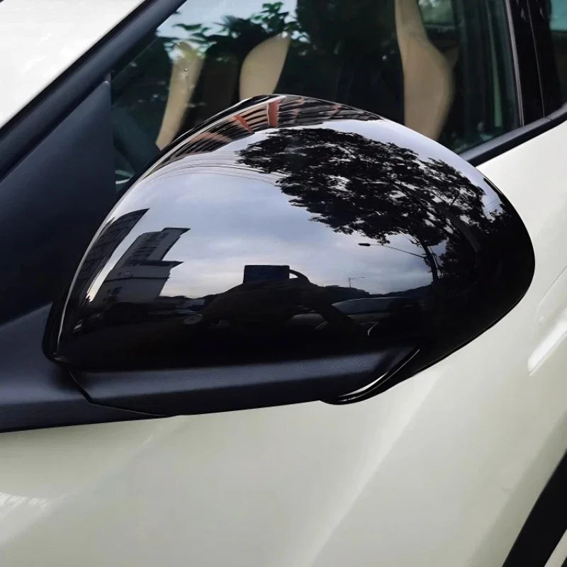 Glossy black carbon fiber texture side mirror cover for BYD vehicles.
