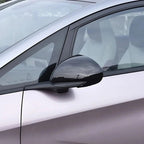 Glossy black side mirror cover accessory installed on a silver vehicle.