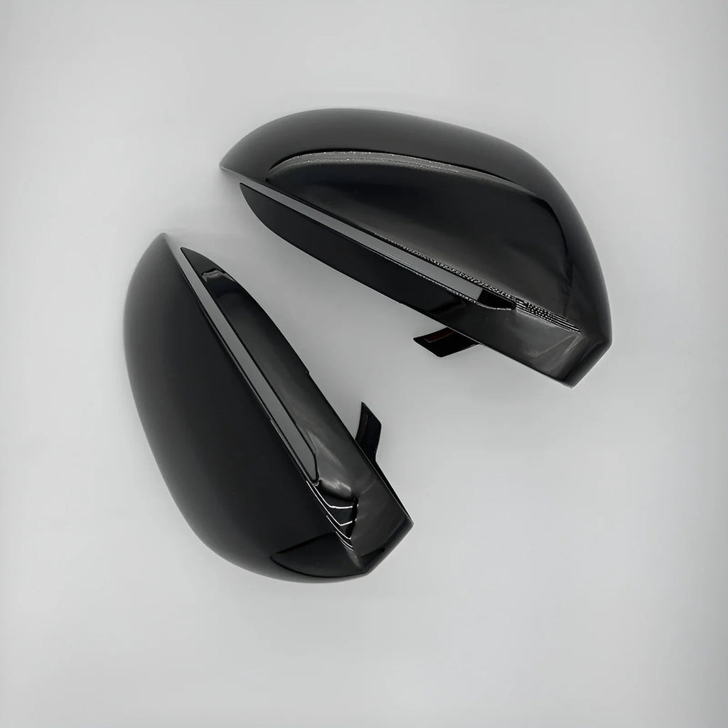 Glossy black aerodynamic car side mirror covers with a sleek, polished finish.
