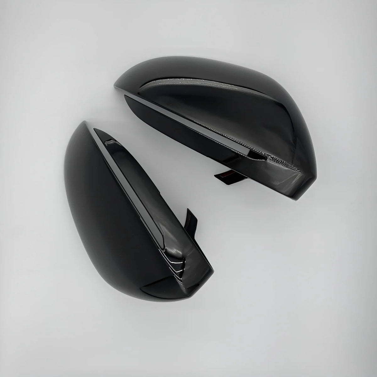 Glossy black aerodynamic car side mirror covers with a sleek, polished finish.
