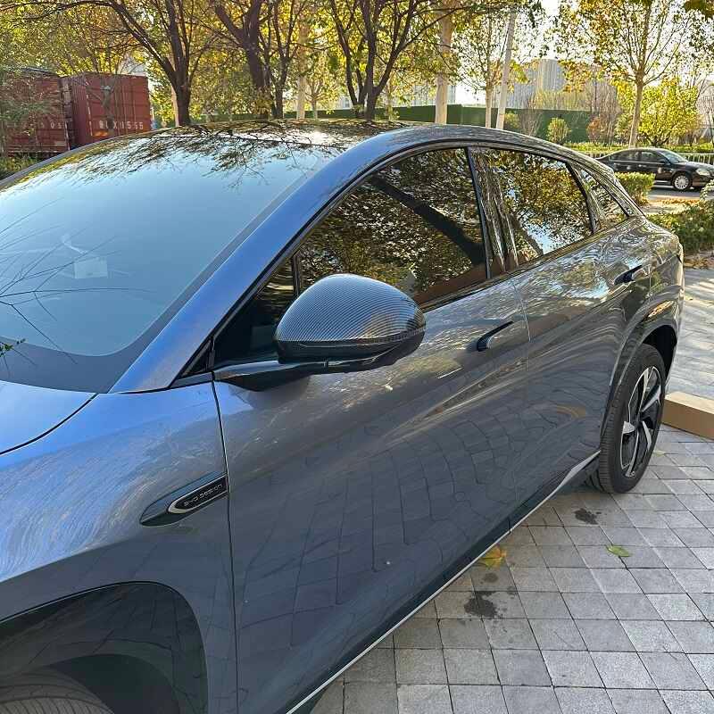 Grey car featuring a sleek carbon fiber mirror cover for a sporty, high-end look.