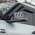 Carbon fiber texture side mirror cover with a sporty ribbed design for a white vehicle.