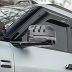 Carbon fiber texture side mirror cover with a sporty ribbed design for a white vehicle.