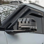 Glossy black side mirror cover with integrated LED signal light and sleek aerodynamic fins.