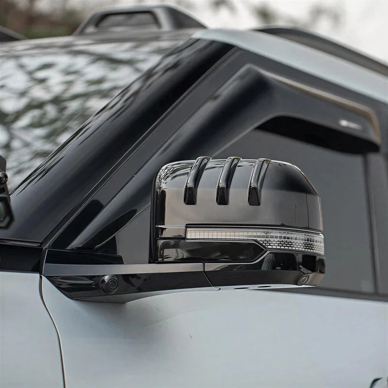 Glossy black side mirror cover with integrated LED signal light and sleek aerodynamic fins.