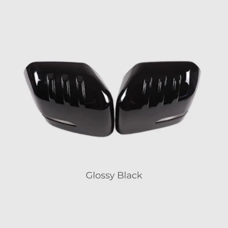 Glossy black side mirror covers with a sleek, aerodynamic ribbed design.