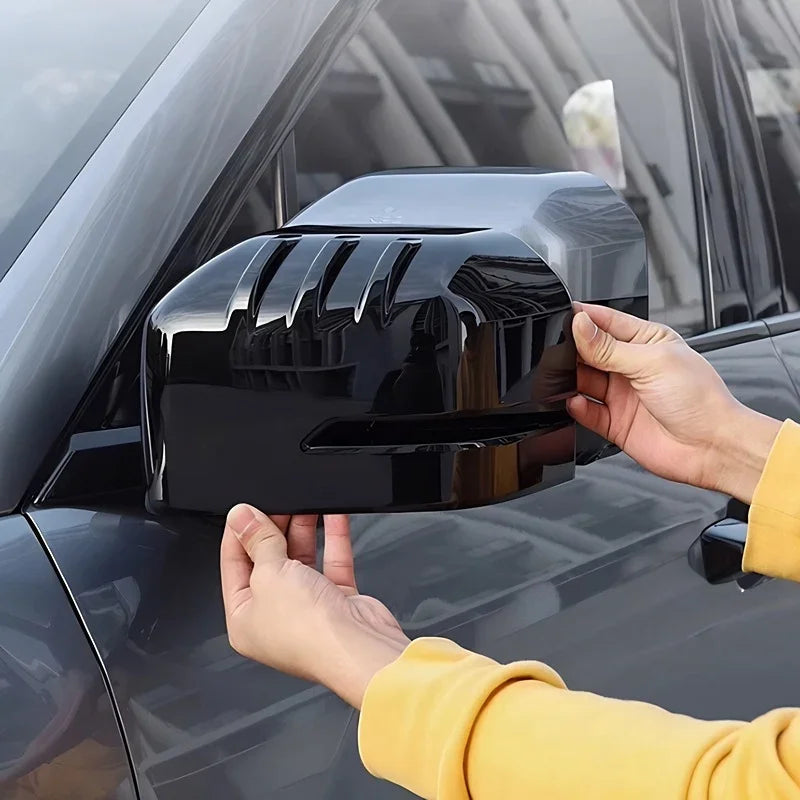Glossy black ABS plastic side mirror cover for BYD, featuring a sleek aerodynamic design.