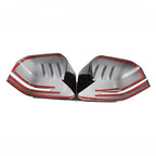 Pair of silver and black car mirror covers with distinctive red accent lines