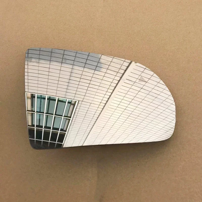 Reflective decorative wall art featuring a modern white tiled architectural design.
