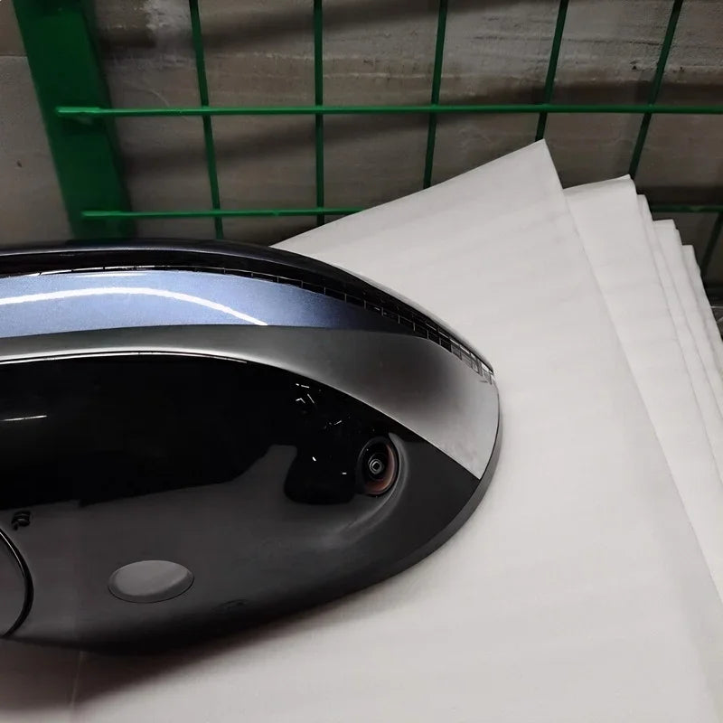 Close-up of a sleek black and silver automotive accessory with a built-in camera lens.