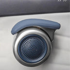 Close-up of a silver and blue automotive speaker grille with a protective rubber cover.