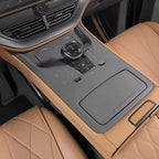 Tan leather car interior featuring a premium black center console and quilted diamond-stitch seats.