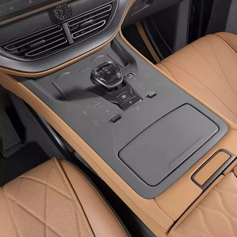 Tan leather car interior featuring a premium black center console and quilted diamond-stitch seats.
