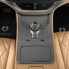Tan quilted leather car interior featuring a sleek black center console and gear shifter.