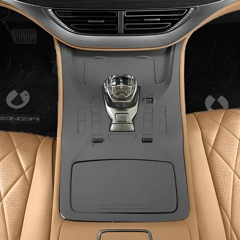 Tan quilted leather car interior featuring a sleek black center console and gear shifter.