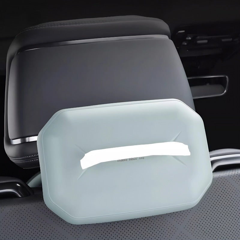 Light grey silicone tissue box holder attached to a black car headrest for organized storage.
