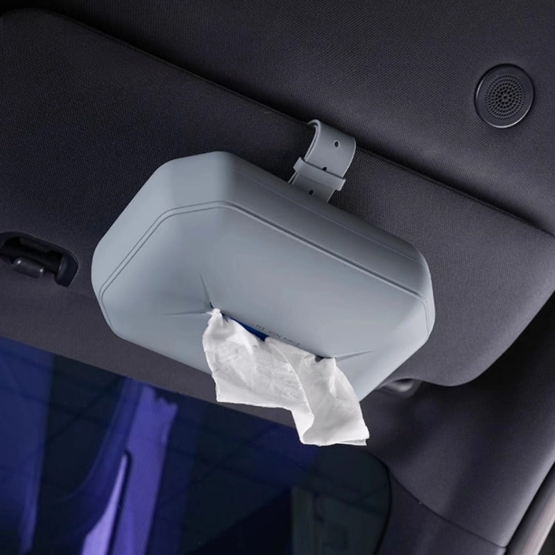 Grey durable plastic car tissue box mounted on a sun visor for convenient interior access.