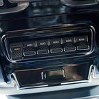 Glossy black auxiliary switch panel for BYD car with six AUX ports and textured buttons.