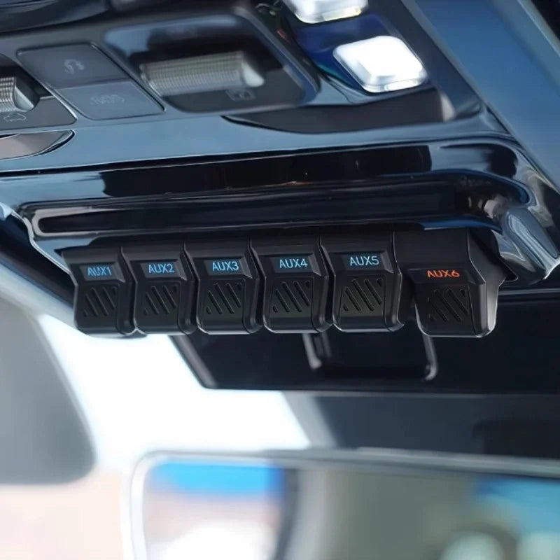 Professional black plastic overhead auxiliary switch panel with labeled AUX1 to AUX6 buttons.
