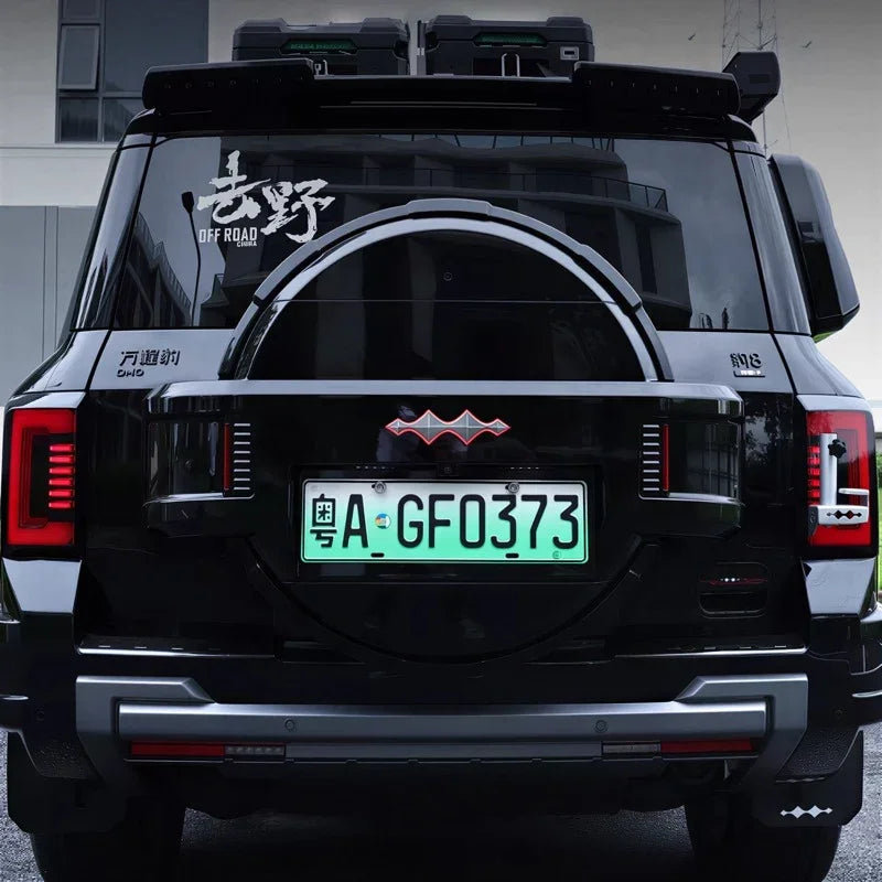 Rear view of a black BYD off-road SUV featuring a custom spare tire cover and roof cargo boxes.