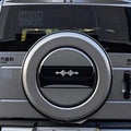 Silver metallic spare tire cover with a sleek black center accent on a vehicle rear.
