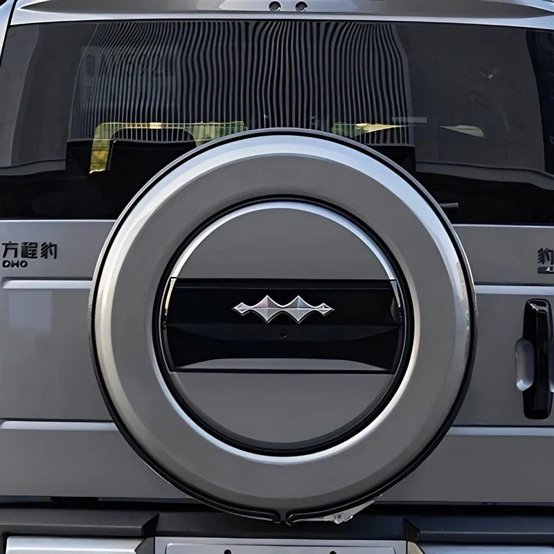 Silver metallic spare tire cover with a sleek black center accent on a vehicle rear.