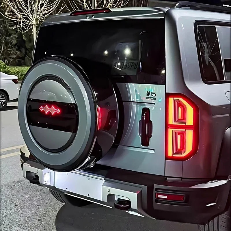 Silver BYD Fang Cheng Bao 5 rear view featuring a black spare tire cover with red LED accents.