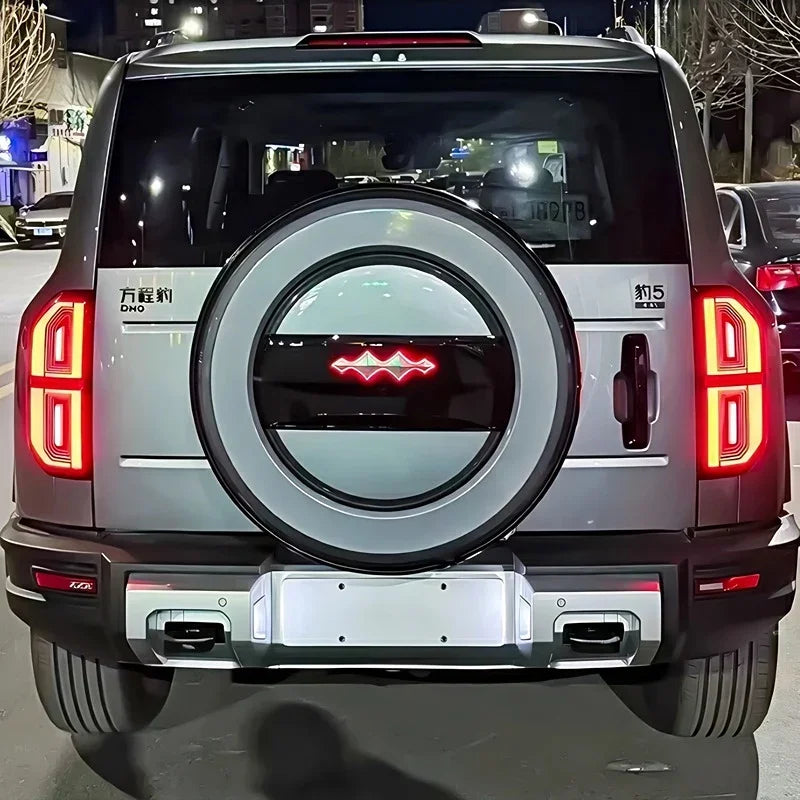 Rear view of a silver BYD Fangchengbao Bao 5 SUV featuring a distinctive circular spare tire cover.