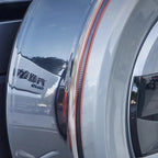 Sleek silver metallic car exterior featuring a vertical red LED taillight strip.
