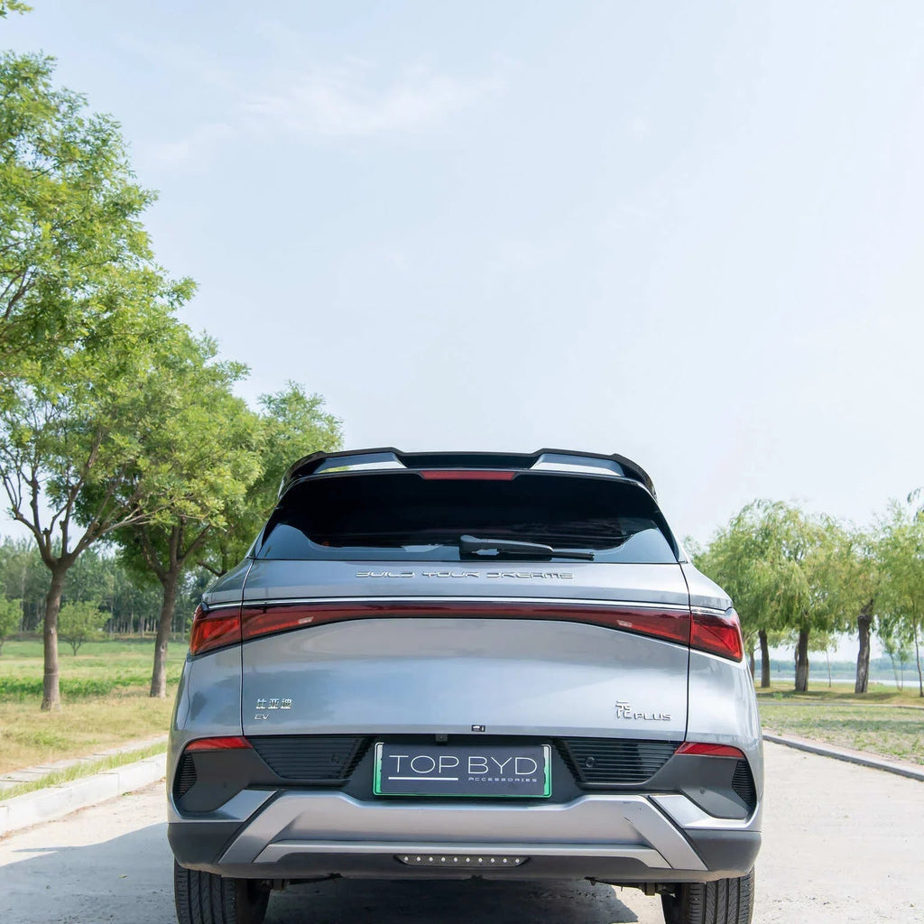 Rear view of a silver BYD T Plus EV showing a sleek metallic finish and modern LED taillights.