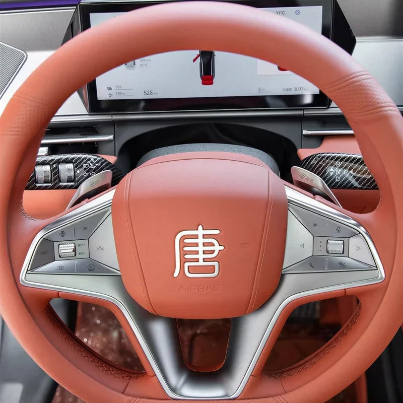 Luxury orange leather steering wheel cover for BYD Tang with detailed stitching.