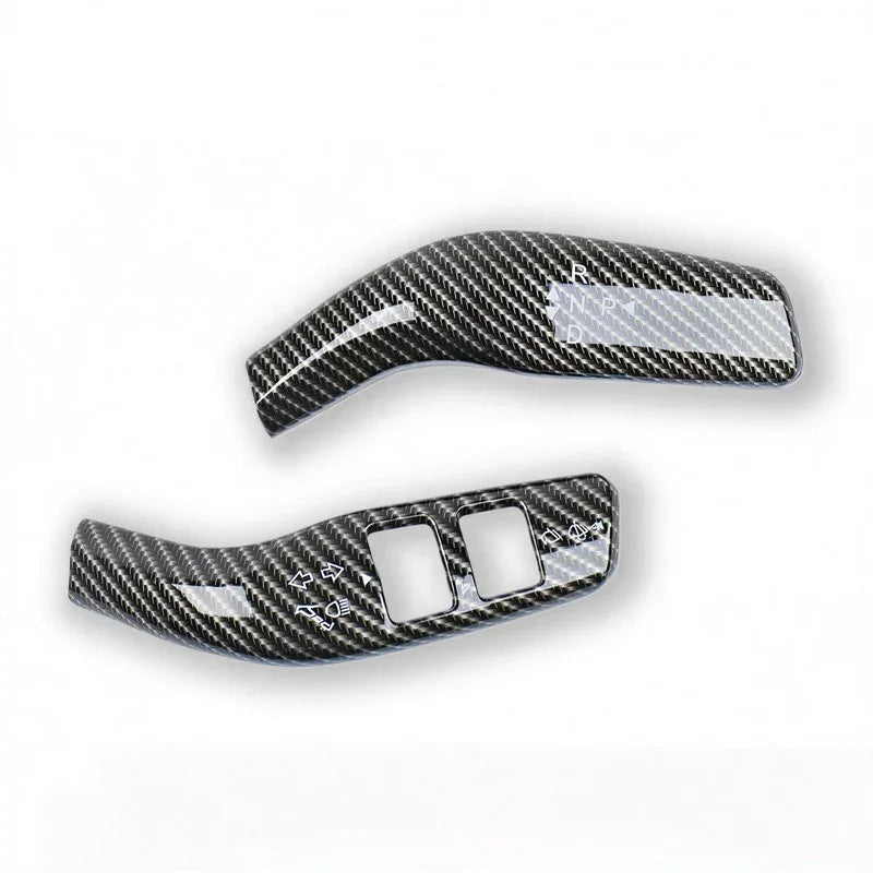 Pair of carbon fiber texture gear shift and control panel covers in black and grey.