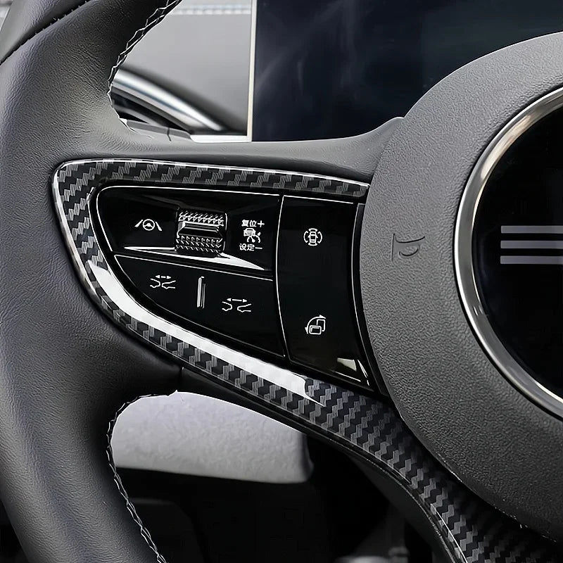 Black carbon fiber texture steering wheel trim with integrated control buttons.