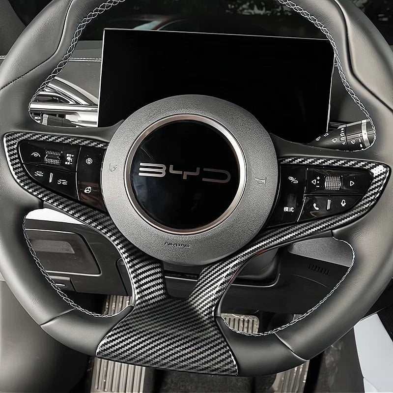 Black leather steering wheel with premium carbon fiber trim and silver accents for BYD.