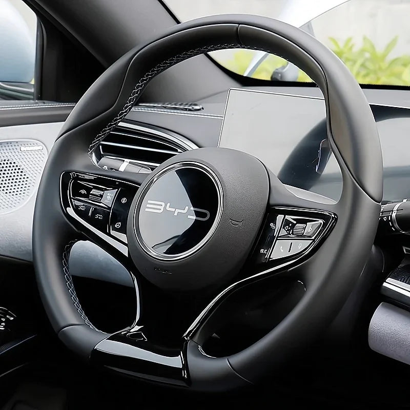 Black leather-wrapped steering wheel with white stitching and glossy black accents for BYD.