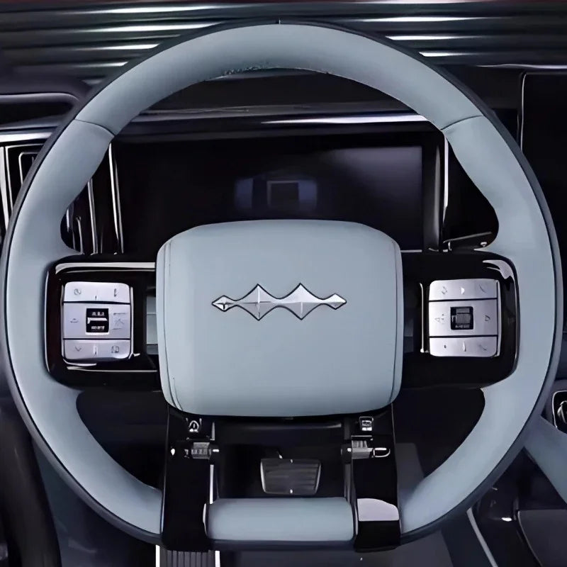 Light grey leather-wrapped steering wheel with integrated control buttons for BYD vehicles.