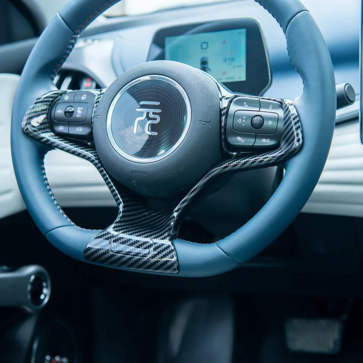 Blue leather steering wheel with carbon fiber accents for BYD vehicle interior