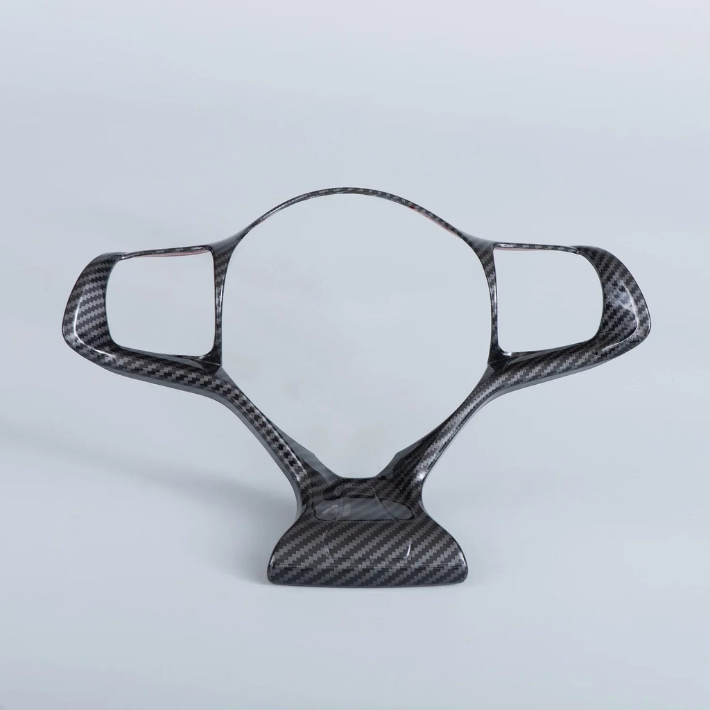 Sleek black carbon fiber steering wheel trim with a high-gloss patterned finish.