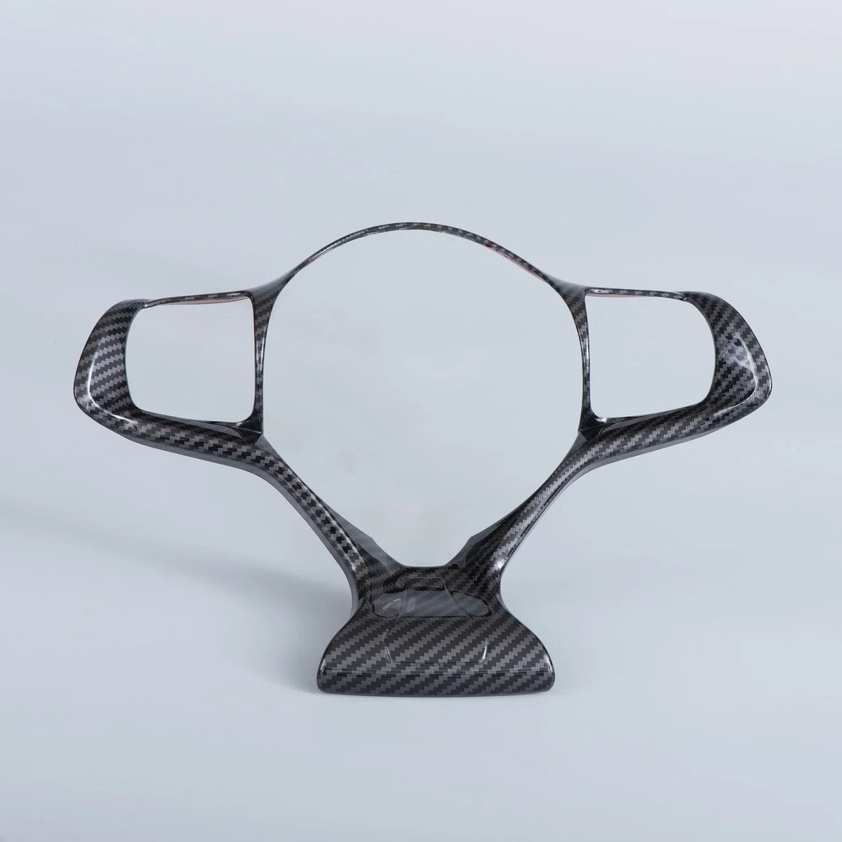 Sleek black carbon fiber steering wheel trim with a high-gloss patterned finish.