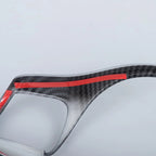 Grey carbon fiber car accessory with red protective tape accents