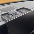 Matte black textured dashboard storage tray for BYD, holding glasses near the screen.