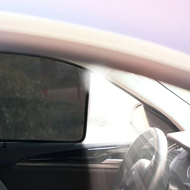 Professional black mesh car side window sunshade installed in a vehicle interior.
