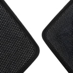 Close-up of black textured car floor mats with durable synthetic fiber material.