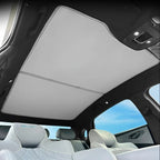 White fabric sunroof shade installed inside a car to block sunlight and heat.