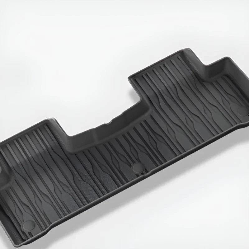 Durable black TPE custom-fit car floor mat with textured anti-slip surface.